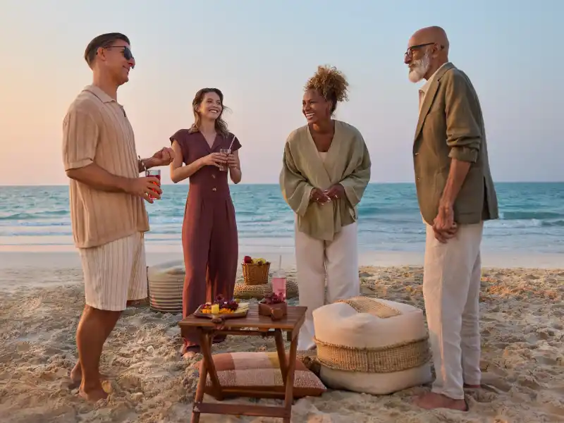 Beachside Living at Fahid Residences Number 1 Real Estate Portal in UAE Number 1 Real Estate Portal in UAE People chilling by the beach in Fahid Residences
